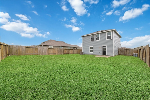 rear view of property featuring a patio and a yard