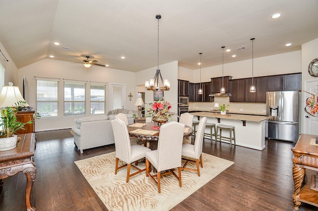 dining space with lofted ceiling, ceiling fan with notable chandelier, and dark hardwood / wood-style flooring