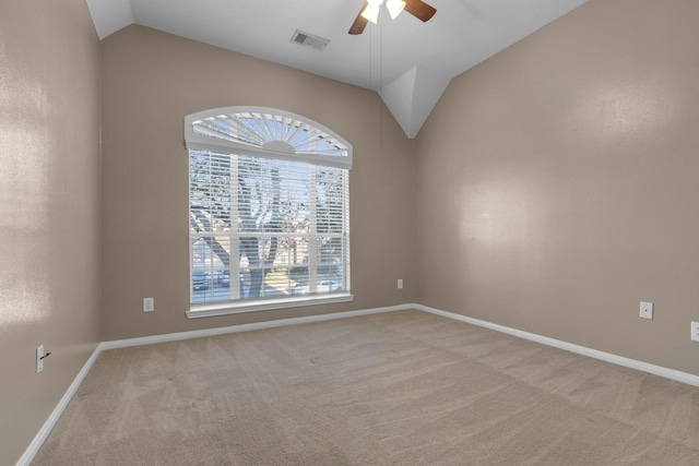 carpeted empty room featuring vaulted ceiling and ceiling fan