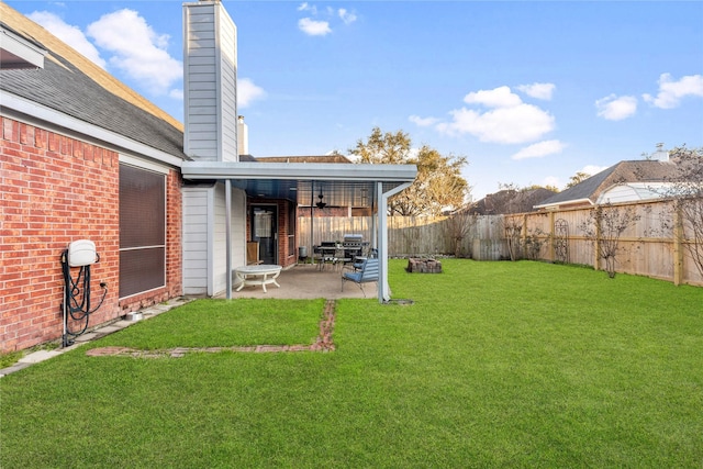 view of yard featuring ceiling fan and a patio