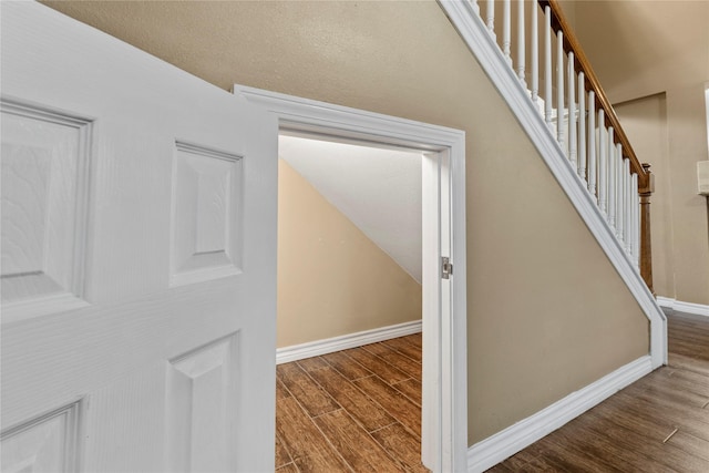 staircase featuring wood-type flooring