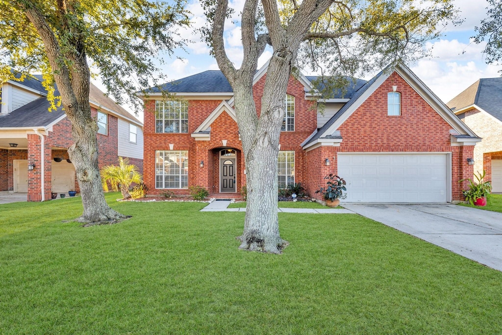 front facade featuring a garage and a front lawn