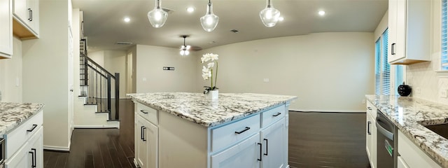 kitchen with a kitchen island, pendant lighting, and white cabinets