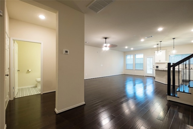 living room featuring dark wood-type flooring and ceiling fan