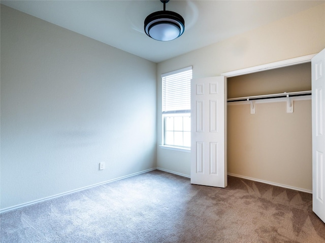 unfurnished bedroom featuring carpet floors and a closet