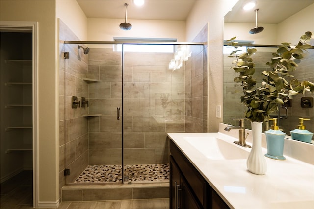 bathroom with vanity and a shower with door