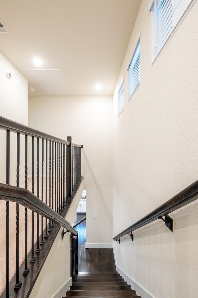 stairs featuring hardwood / wood-style flooring