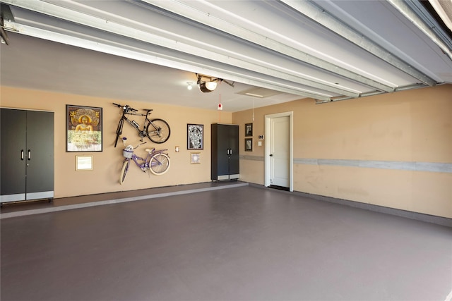 garage with a garage door opener and baseboards