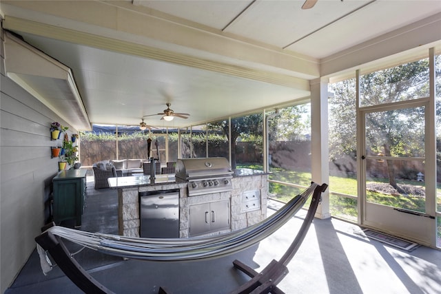 sunroom featuring ceiling fan and plenty of natural light