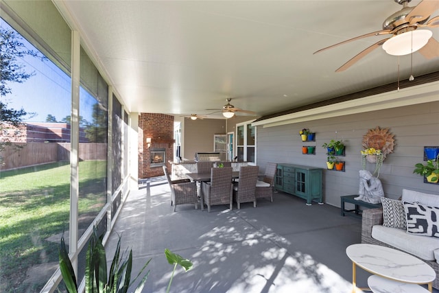 sunroom / solarium featuring ceiling fan