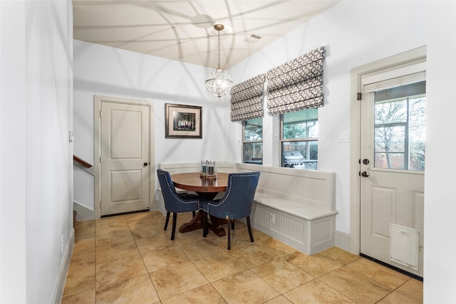 tiled dining space featuring a chandelier, visible vents, and baseboards