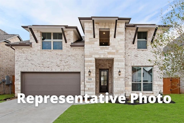 view of front of house with driveway, a front lawn, an attached garage, and stone siding