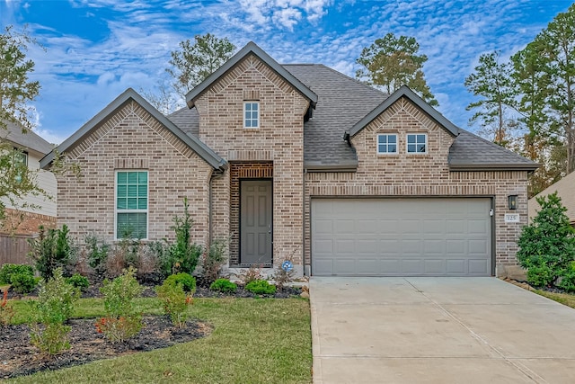 front of property featuring a garage and a front yard