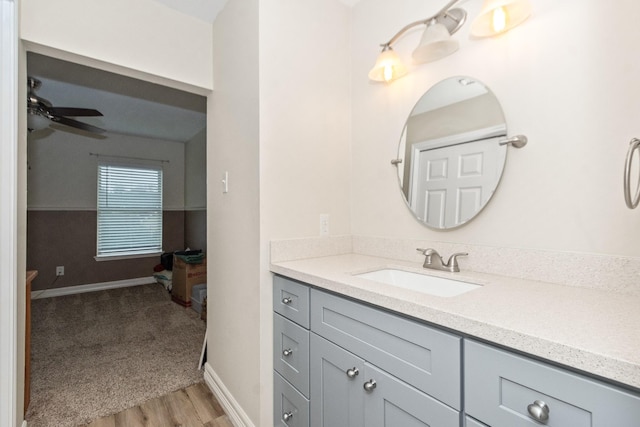 bathroom featuring hardwood / wood-style flooring, ceiling fan, and vanity