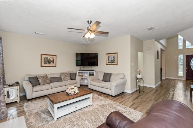 living room featuring ceiling fan and hardwood / wood-style floors