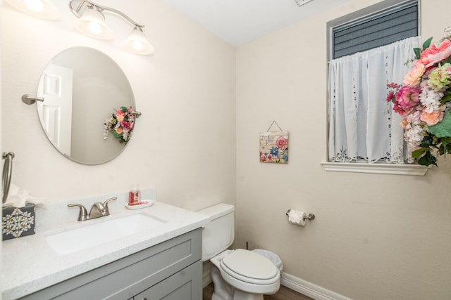 bathroom featuring vanity and toilet