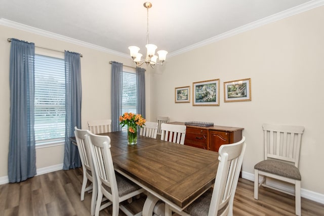 dining room with ornamental molding, a notable chandelier, and dark hardwood / wood-style flooring