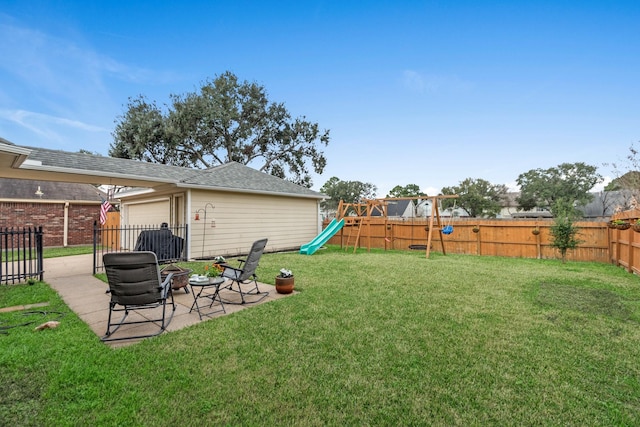 view of yard with a playground and a patio area