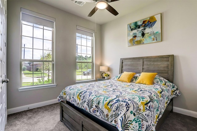 bedroom featuring ceiling fan, multiple windows, and carpet