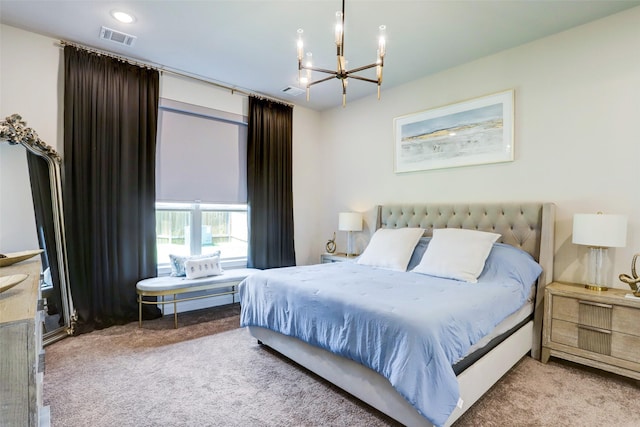 carpeted bedroom featuring an inviting chandelier