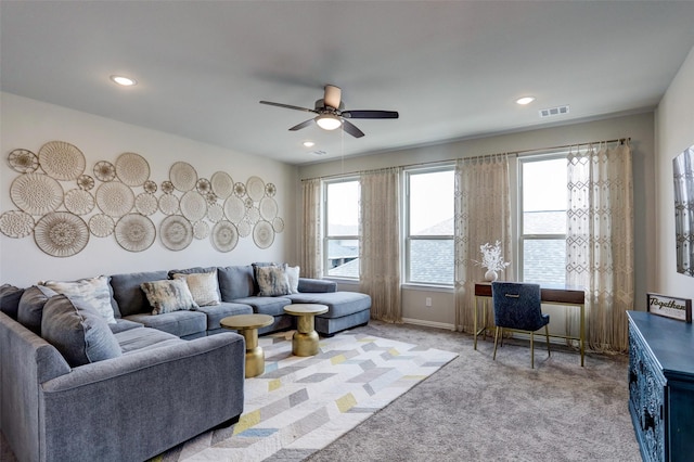 living room featuring light colored carpet and ceiling fan