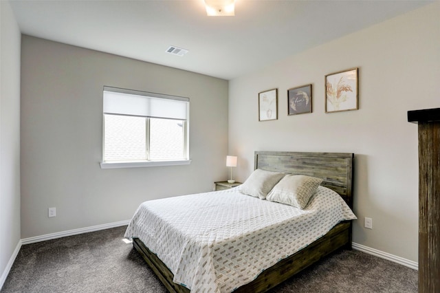 bedroom with dark colored carpet