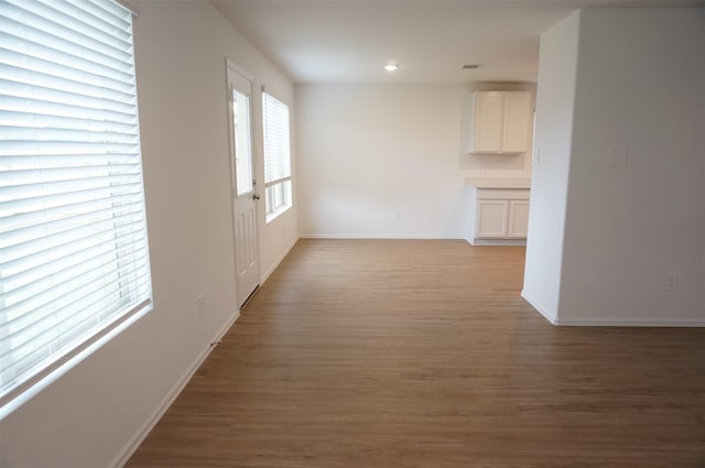 corridor with light hardwood / wood-style flooring