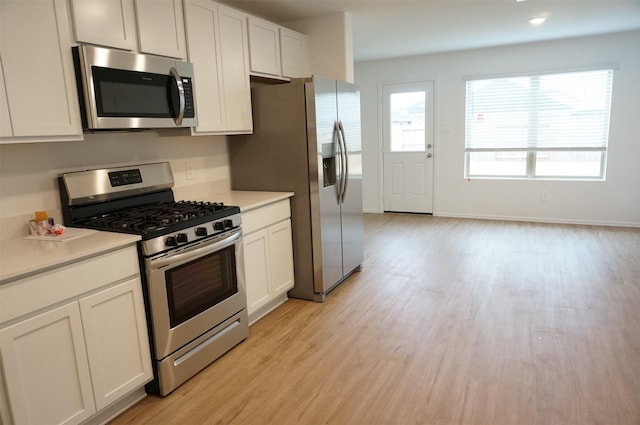 kitchen with white cabinetry, appliances with stainless steel finishes, and light wood-type flooring