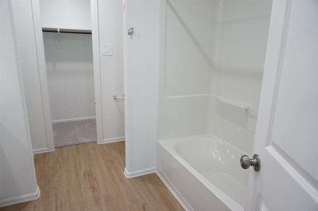 bathroom featuring hardwood / wood-style flooring and a bathing tub