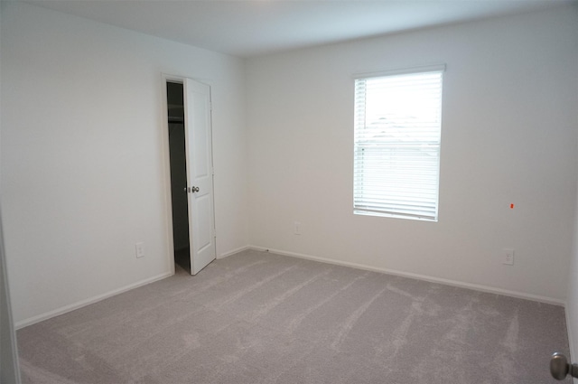 unfurnished room with light colored carpet