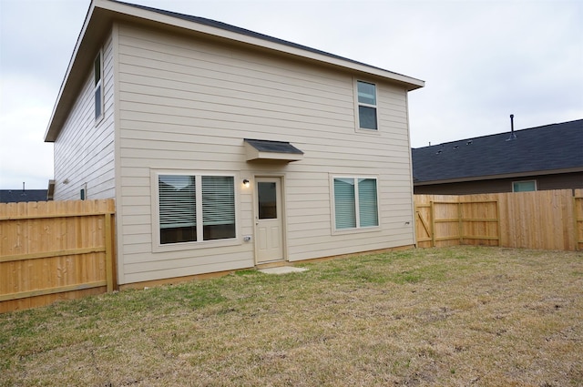 rear view of property with a yard