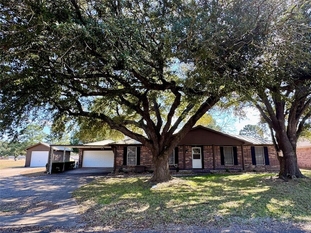 ranch-style home with a garage and a front lawn