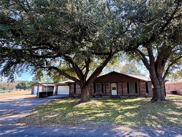 ranch-style home with a garage and a front yard