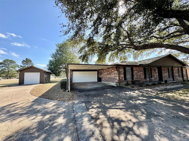 ranch-style house with an outbuilding and a garage