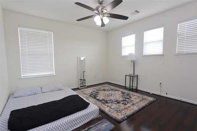 bedroom with ceiling fan and dark hardwood / wood-style flooring