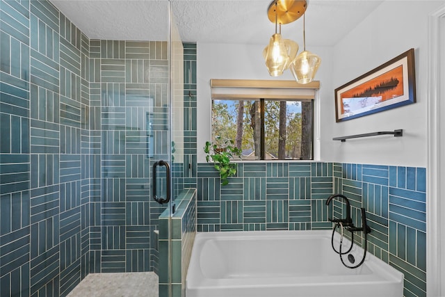 bathroom with a textured ceiling, a tile shower, a bath, and tile walls