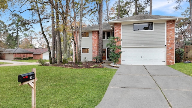 view of front of house featuring a front yard, concrete driveway, brick siding, and an attached garage