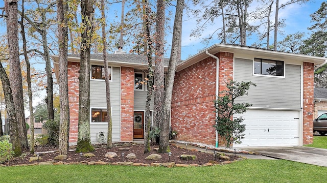 view of front of home featuring a garage, driveway, and brick siding