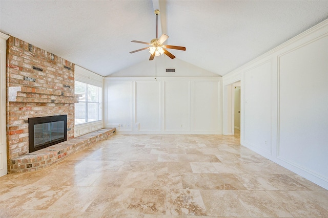 unfurnished living room featuring a fireplace, ceiling fan, and lofted ceiling