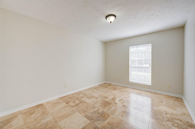 spare room with a textured ceiling