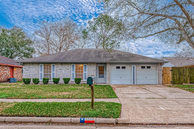 ranch-style house with a garage and a front lawn