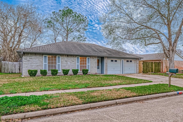 ranch-style house featuring a garage and a front yard