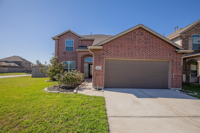 traditional-style house featuring a garage, brick siding, concrete driveway, and a front lawn