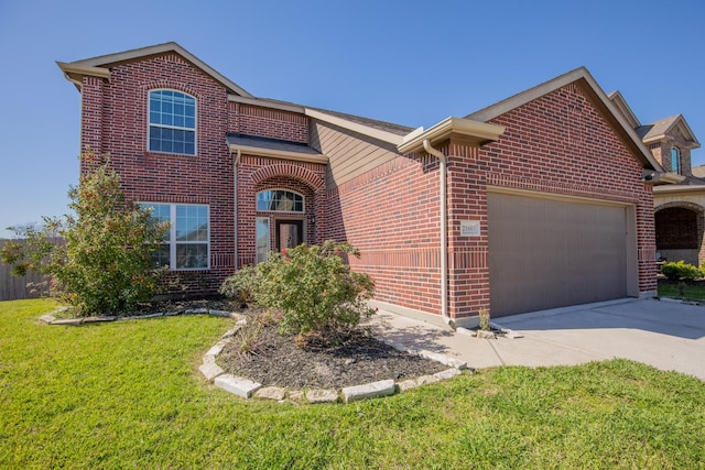 traditional home with a front lawn, a garage, brick siding, and driveway