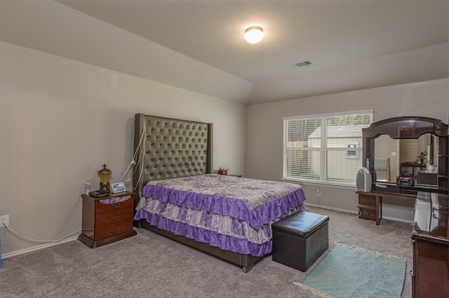 bedroom featuring lofted ceiling and carpet floors