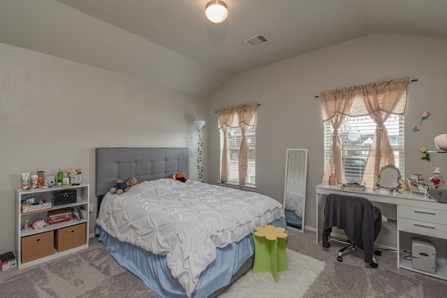 bedroom with light colored carpet and vaulted ceiling