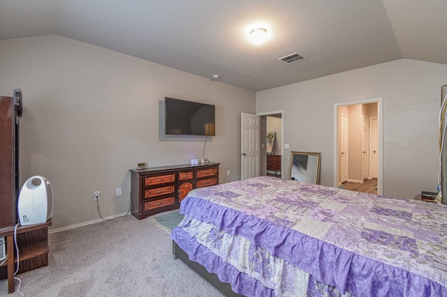 carpeted bedroom featuring lofted ceiling