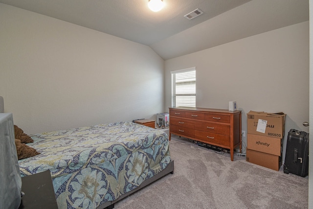 carpeted bedroom featuring lofted ceiling