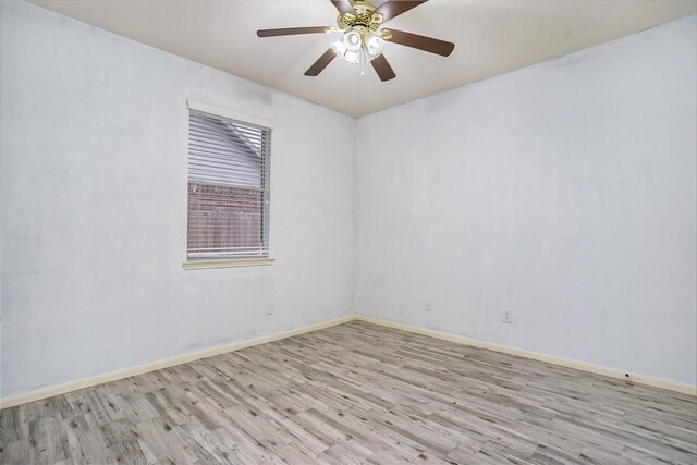 empty room with light hardwood / wood-style flooring and ceiling fan