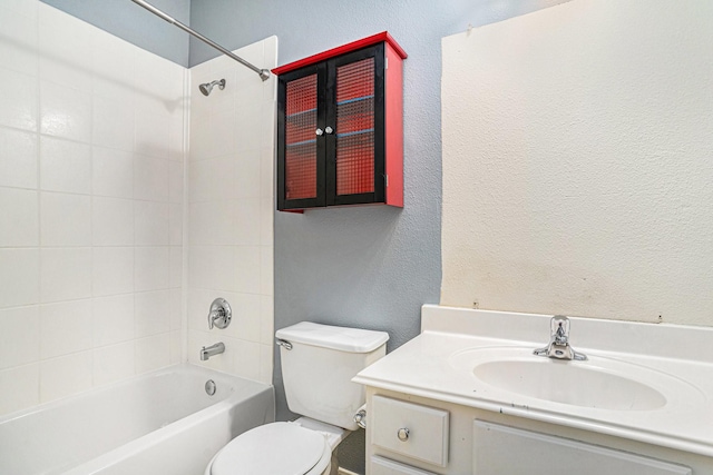 full bathroom featuring vanity, tiled shower / bath, and toilet